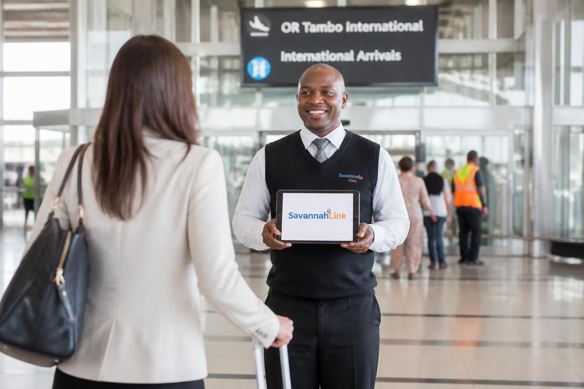 Driver greeting an arriving guest at OR Tambo International
