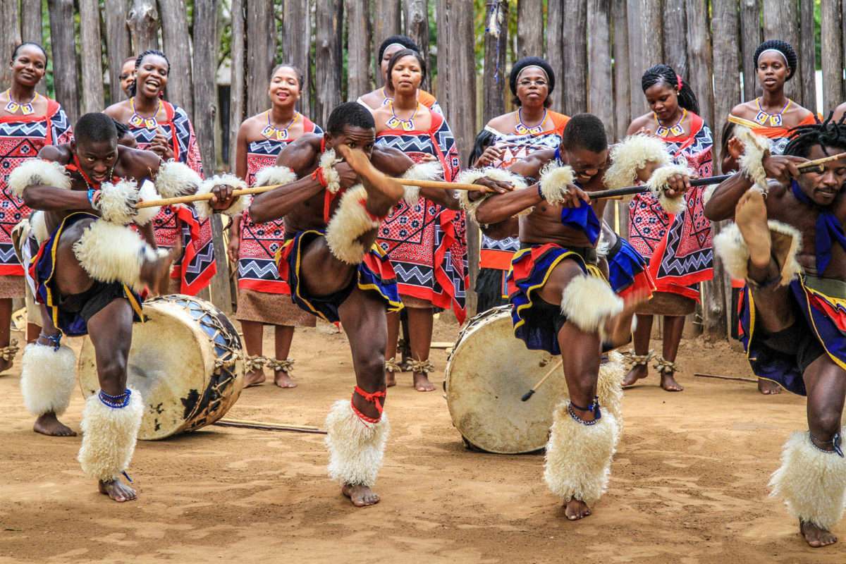 Sibhaca dancers and singers in traditional dress performing at Mantenga Cultural Village, Eswatini